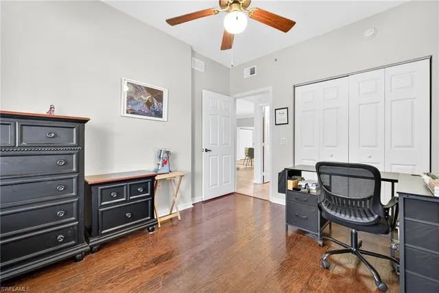 a living room with furniture and a dresser