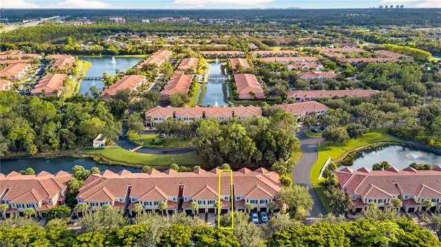 an aerial view of residential houses with outdoor space and river