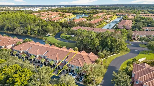 an aerial view of residential houses with outdoor space and swimming pool