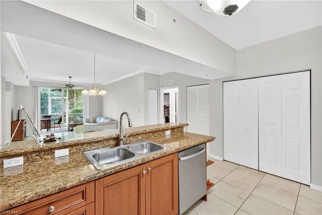 a kitchen with sink a faucet and chandelier