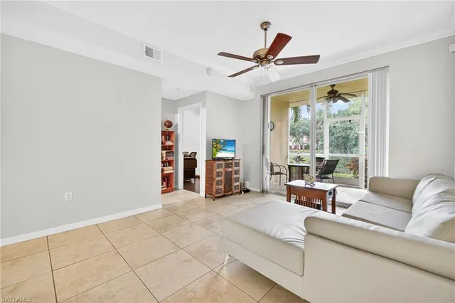 a living room with furniture and large windows