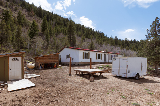 3902 Beaver Creek Road Kamas, UT 84036 - Photo 21 of 33 Property view with a shed, accessory building and a forest view