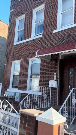 a view of a brick house with large windows