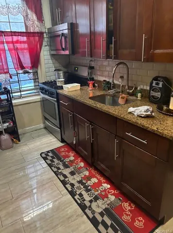 a kitchen with sink cabinets and stove