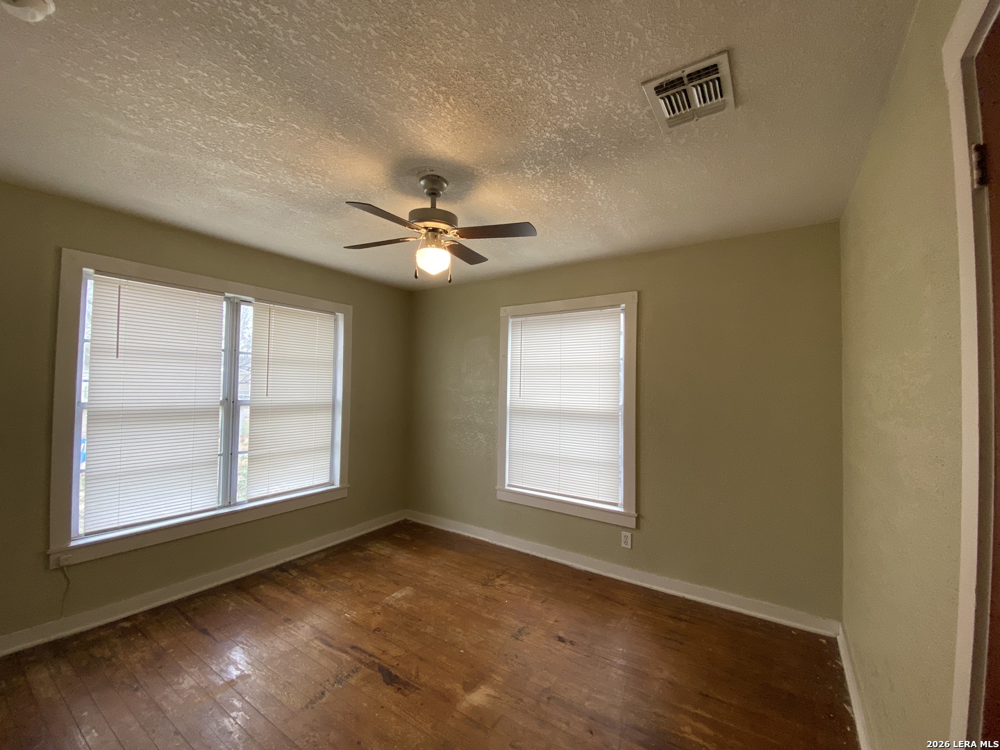 116 Tagert Street Pleasanton, TX 78064 - Photo 5 of 6 a view of an empty room with a window