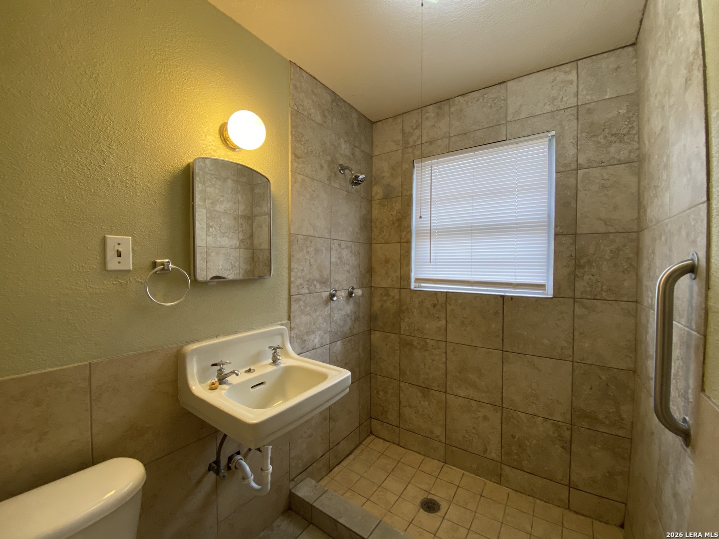 116 Tagert Street Pleasanton, TX 78064 - Photo 6 of 6 a bathroom with a sink mirror and toilet