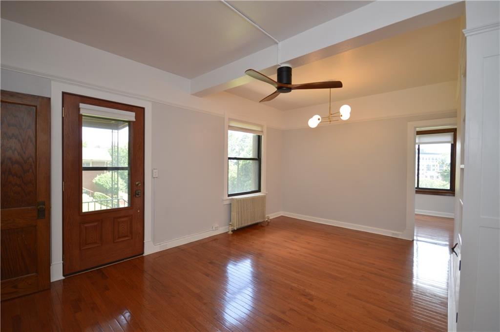 4323 Andover Terrace Pittsburgh, PA 15213 - Photo 14 of 48 a view of an empty room with wooden floor and a window