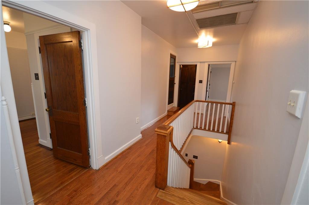 4323 Andover Terrace Pittsburgh, PA 15213 - Photo 25 of 48 a view of a hallway with wooden floor and staircase