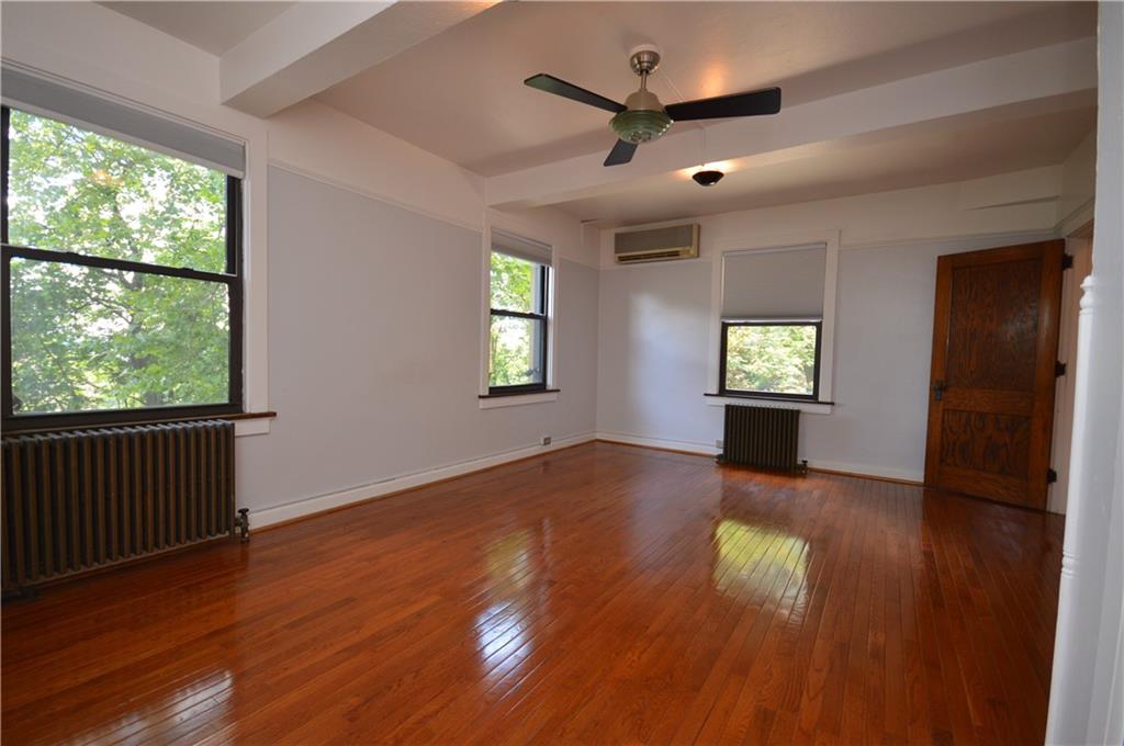 4323 Andover Terrace Pittsburgh, PA 15213 - Photo 26 of 48 an empty room with wooden floor and windows