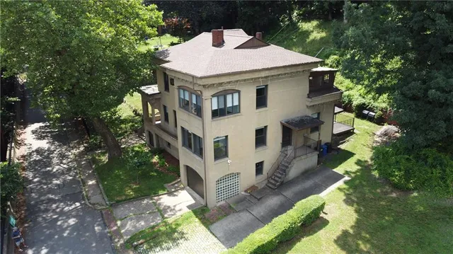 a aerial view of a house with a yard