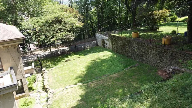 a backyard of a house with yard and outdoor seating