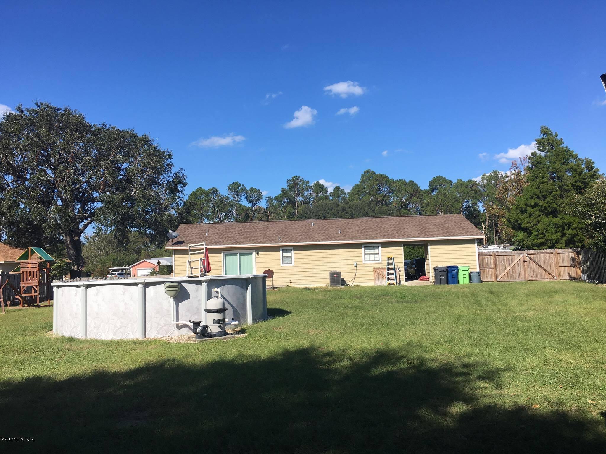 86054 Spring Meadow Avenue Yulee, FL 32097 - Photo 27 of 28 Full back yard with pool