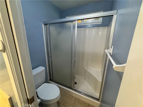 a bathroom with a shower and a toilet