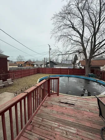 a view of balcony with wooden floor and fence