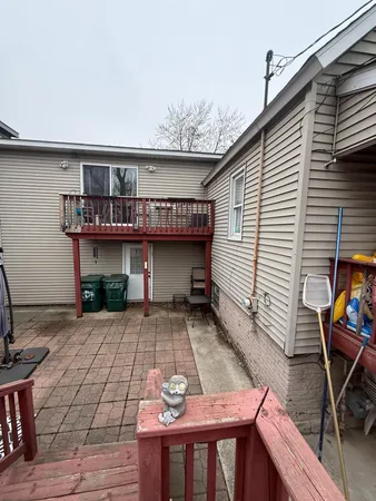 a view of a patio with table and chairs with wooden floor and fence