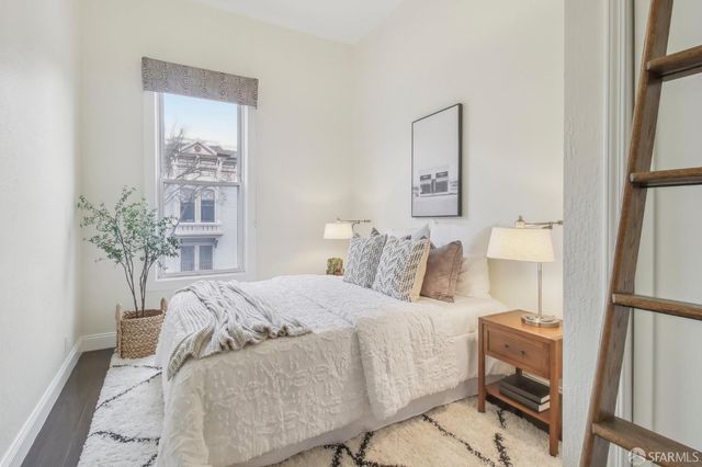 a bedroom with a bed and a potted plant