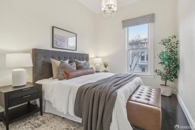 a bedroom with furniture and a window