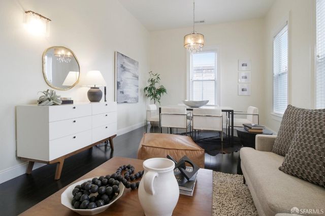 a living room with furniture and a mirror