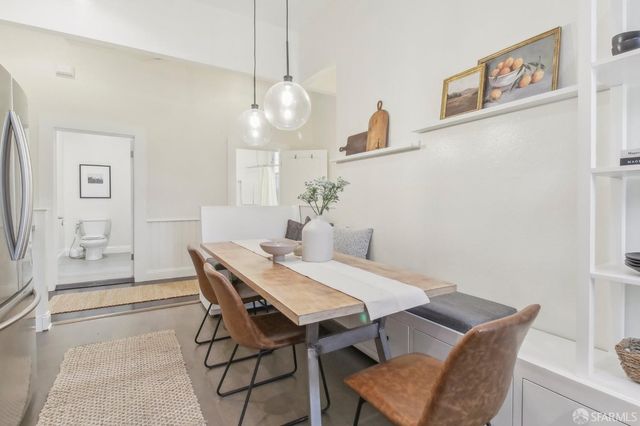a view of a dining room with furniture and chandelier