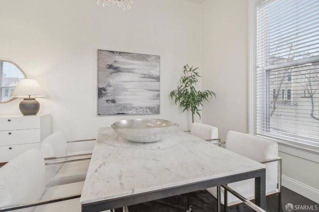 a white bath tub sitting in a bathroom next to a window