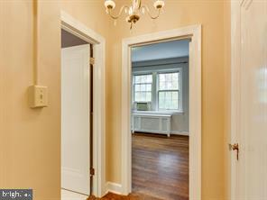 2737 Devonshire Place Northwest, Unit 129 Washington, DC 20008 - Photo 11 of 30 a view of a hallway with wooden floor and a bathroom