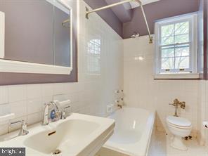 2737 Devonshire Place Northwest, Unit 129 Washington, DC 20008 - Photo 12 of 30 a bathroom with a sink a toilet and shower
