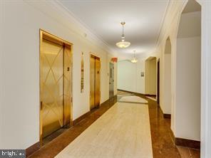 2737 Devonshire Place Northwest, Unit 129 Washington, DC 20008 - Photo 2 of 30 a view of a hallway with wooden floor and a bathroom