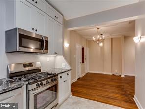 2737 Devonshire Place Northwest, Unit 129 Washington, DC 20008 - Photo 10 of 30 a kitchen with a stove and a microwave