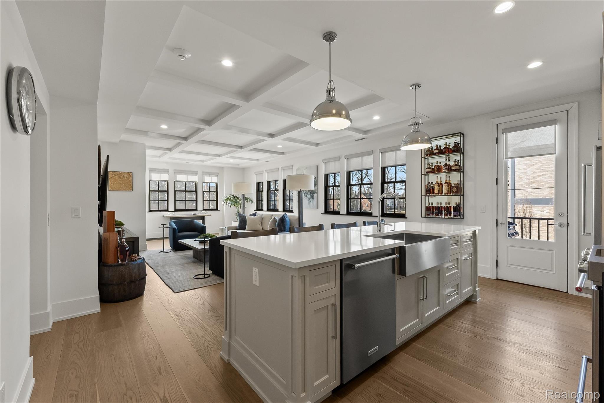 936 West Eleven Mile Road Royal Oak, MI 48067 - Photo 19 of 19 Kitchen featuring coffered ceiling, open floor plan, a kitchen island with sink, stainless steel appliances, and hanging light fixtures