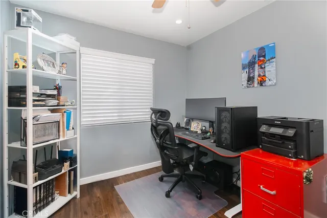 a view of a workspace with furniture and a window