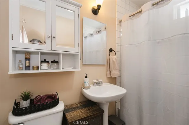 a bathroom with a sink a toilet and mirror