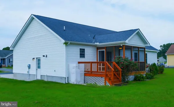 a front view of a house with a garden and deck
