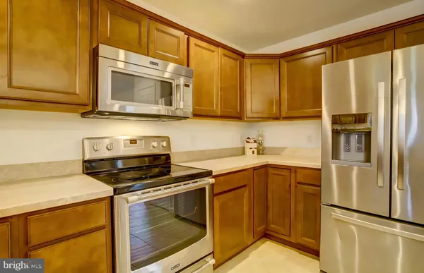 a kitchen with a refrigerator stove and microwave