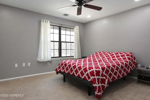 a bed sitting in a bedroom next to a window
