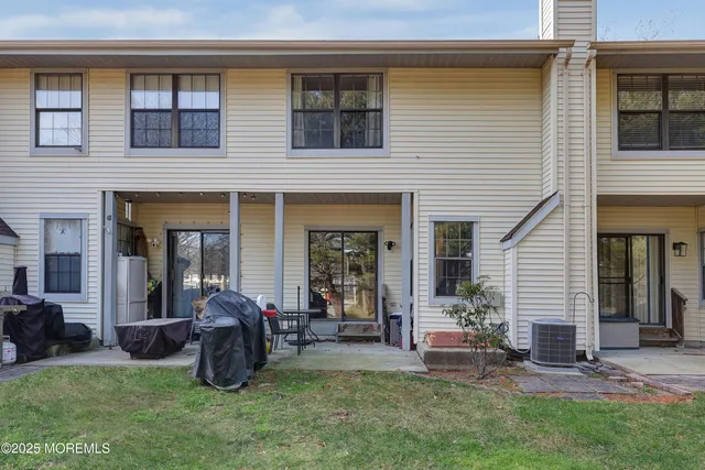 a view of a house with a yard and sitting area