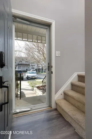 a view of dining room with wooden floor and a floor to ceiling window