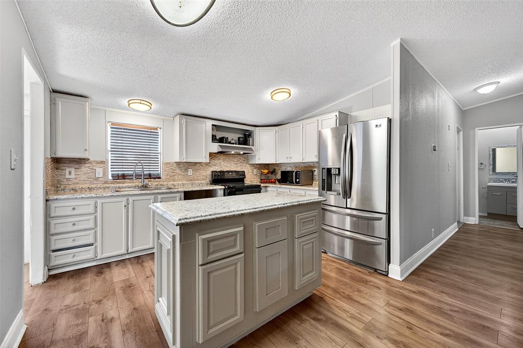1918 East Foster Crossing Road Anna, TX 75409 - Photo 15 of 27 a kitchen with white cabinets and white appliances