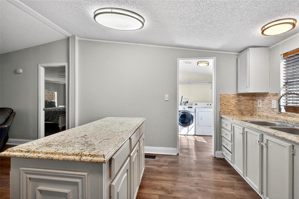 1918 East Foster Crossing Road Anna, TX 75409 - Photo 18 of 27 a kitchen with a sink and refrigerator