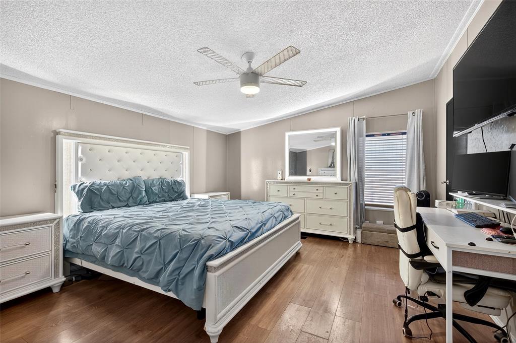 1918 East Foster Crossing Road Anna, TX 75409 - Photo 20 of 27 a bedroom with a bed and a flat screen tv