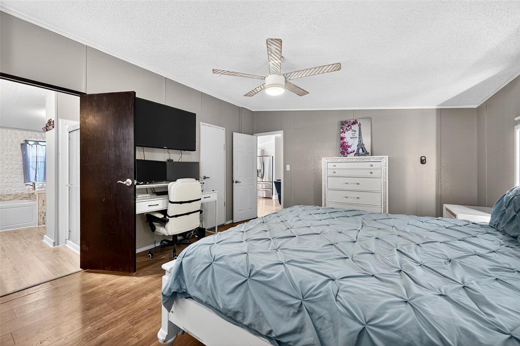 1918 East Foster Crossing Road Anna, TX 75409 - Photo 22 of 27 a bedroom with a bed and a chandelier