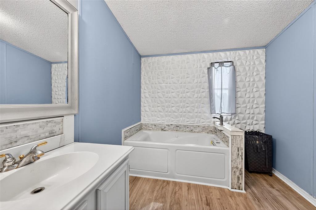1918 East Foster Crossing Road Anna, TX 75409 - Photo 24 of 27 a bathroom with a tub sink and mirror