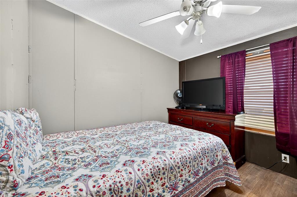 1918 East Foster Crossing Road Anna, TX 75409 - Photo 27 of 27 a bedroom with a bed and a flat screen tv