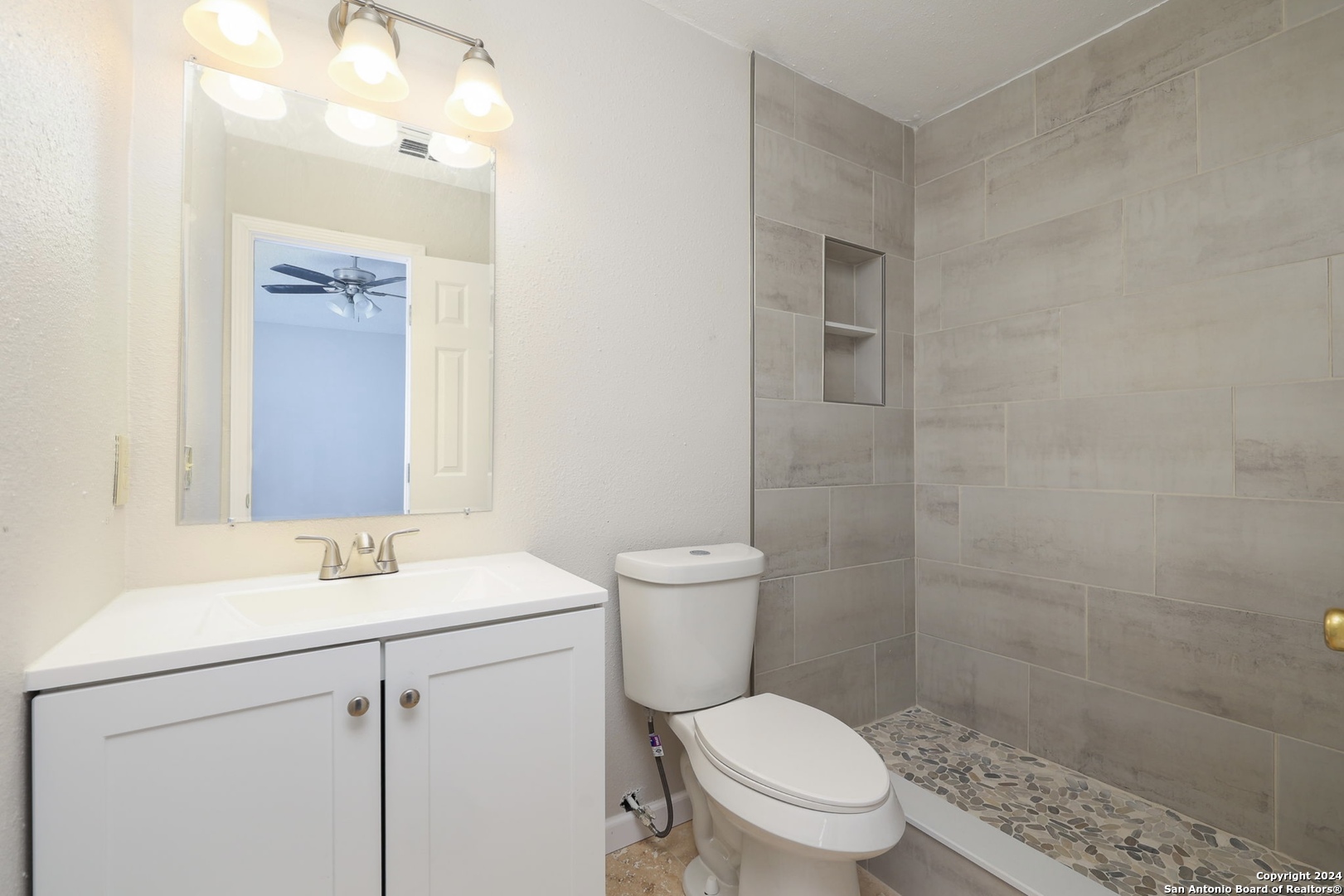 9159 Ridge Mill San Antonio, TX 78250 - Photo 11 of 17 a bathroom with a sink a toilet and shower