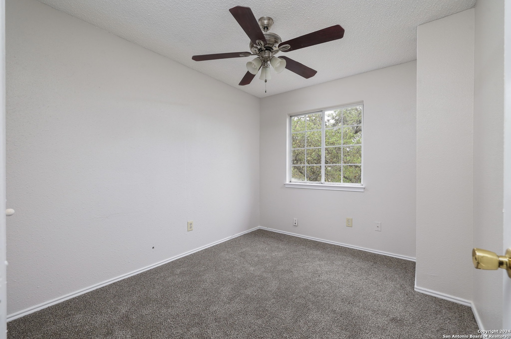 9159 Ridge Mill San Antonio, TX 78250 - Photo 14 of 17 an empty room with a window