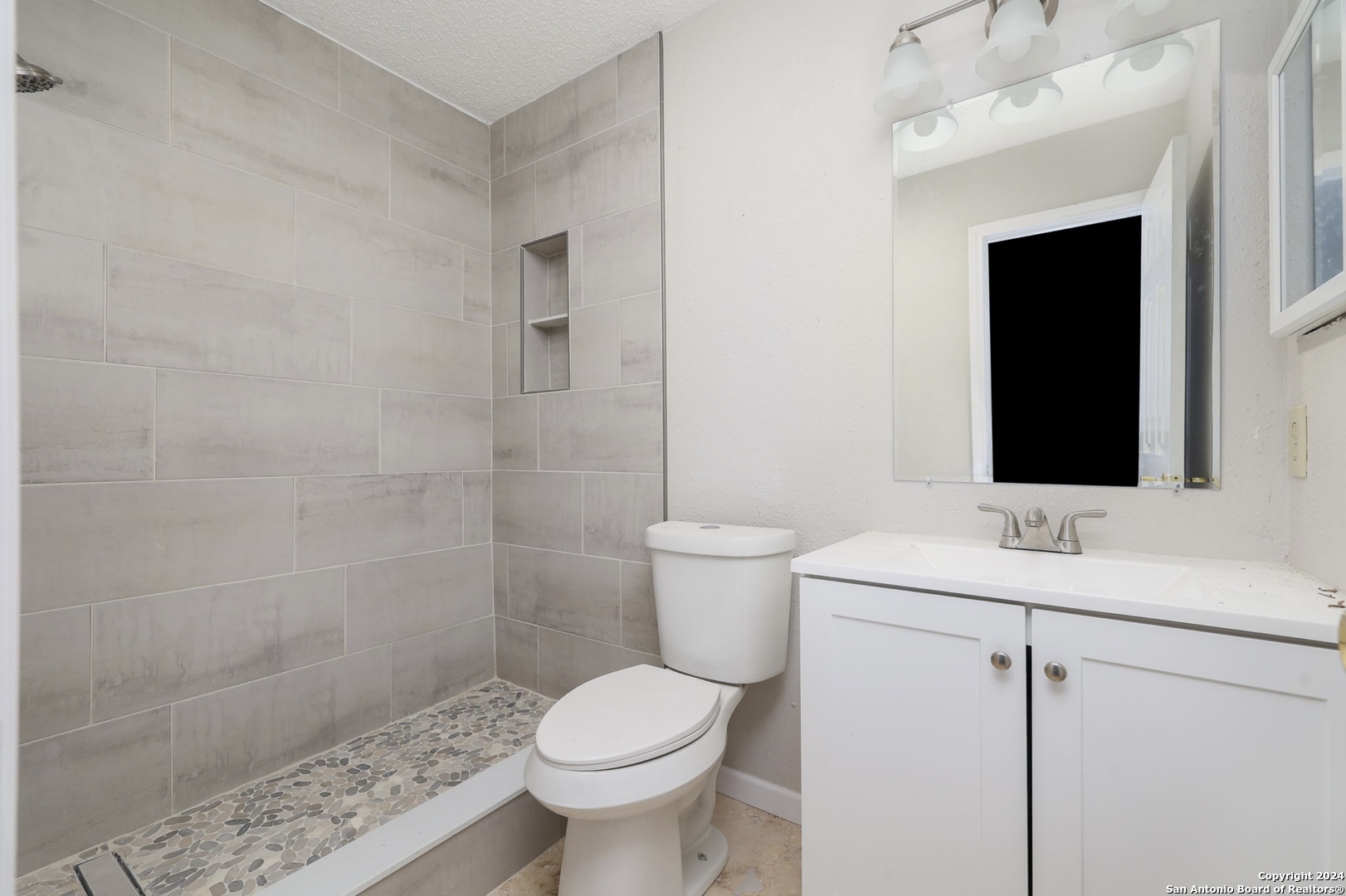 9159 Ridge Mill San Antonio, TX 78250 - Photo 15 of 17 a bathroom with a sink toilet and shower