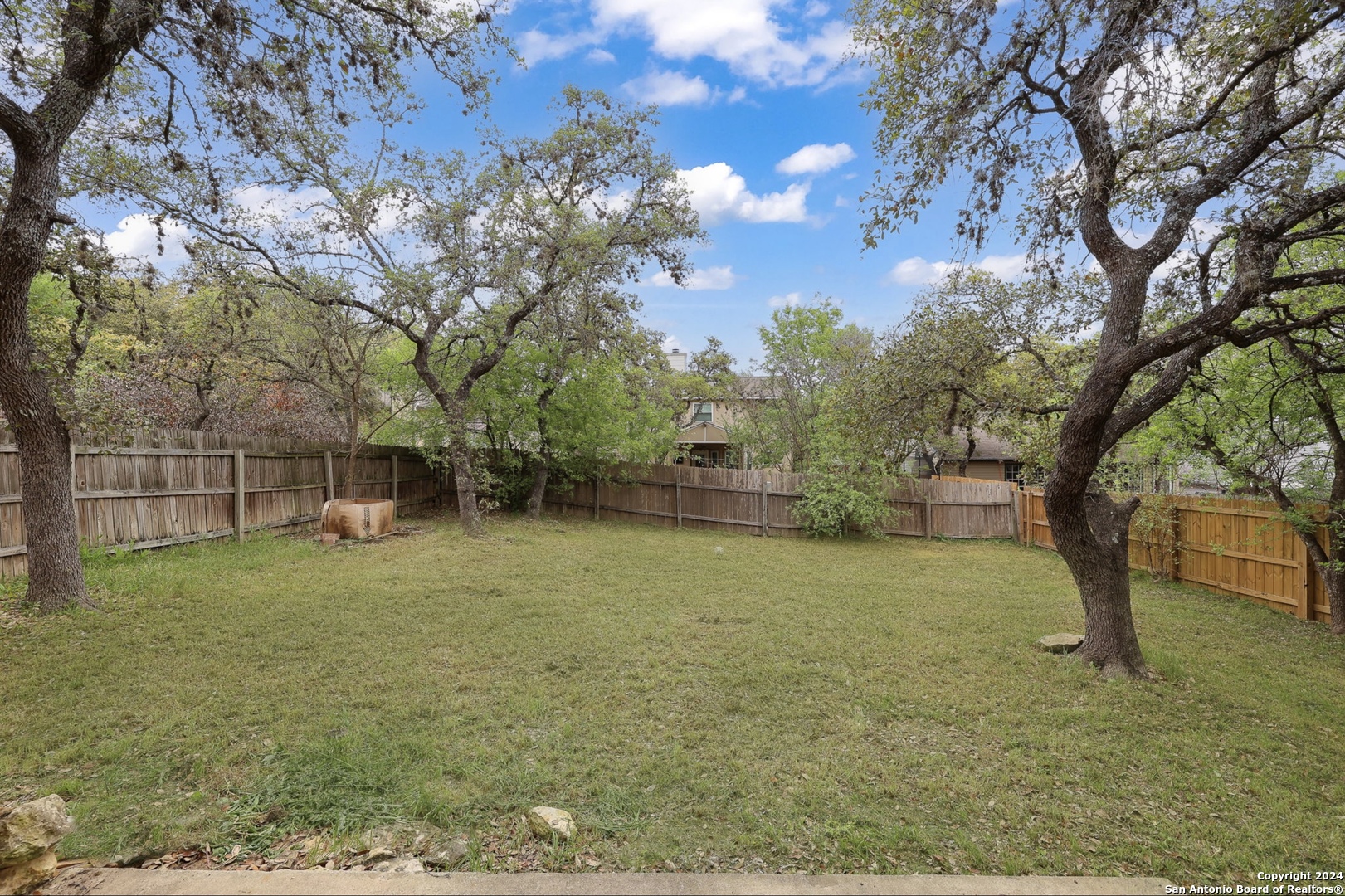 9159 Ridge Mill San Antonio, TX 78250 - Photo 16 of 17 a view of a field with tree in front of it