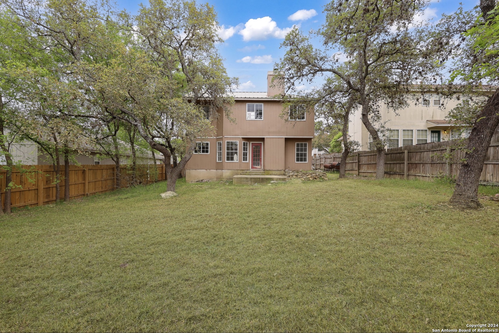9159 Ridge Mill San Antonio, TX 78250 - Photo 17 of 17 a view of a house with a yard
