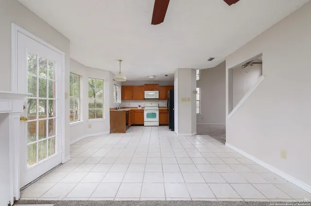 a view of a kitchen with furniture and an empty room