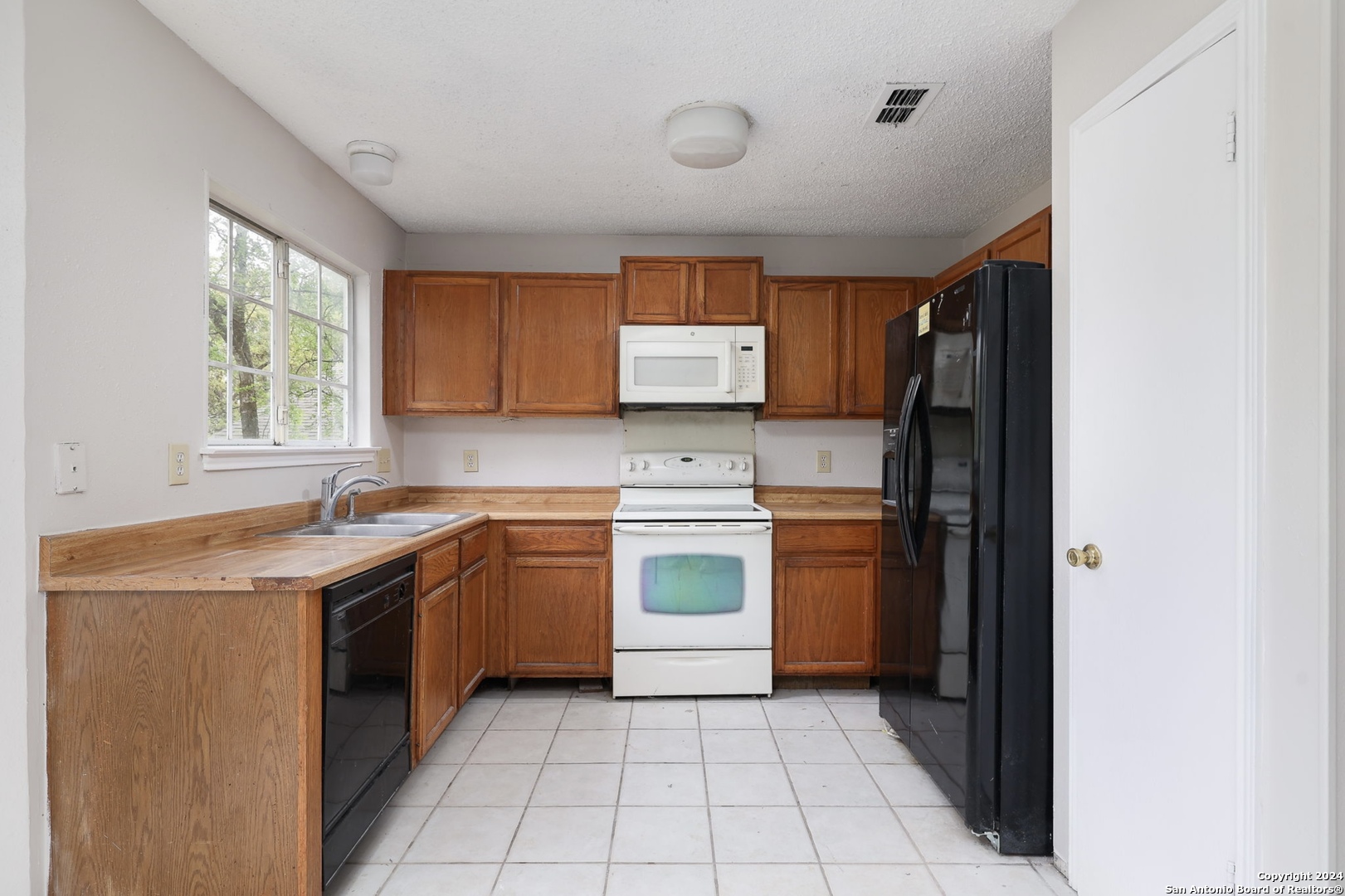 9159 Ridge Mill San Antonio, TX 78250 - Photo 9 of 17 a kitchen with a stove sink and cabinets
