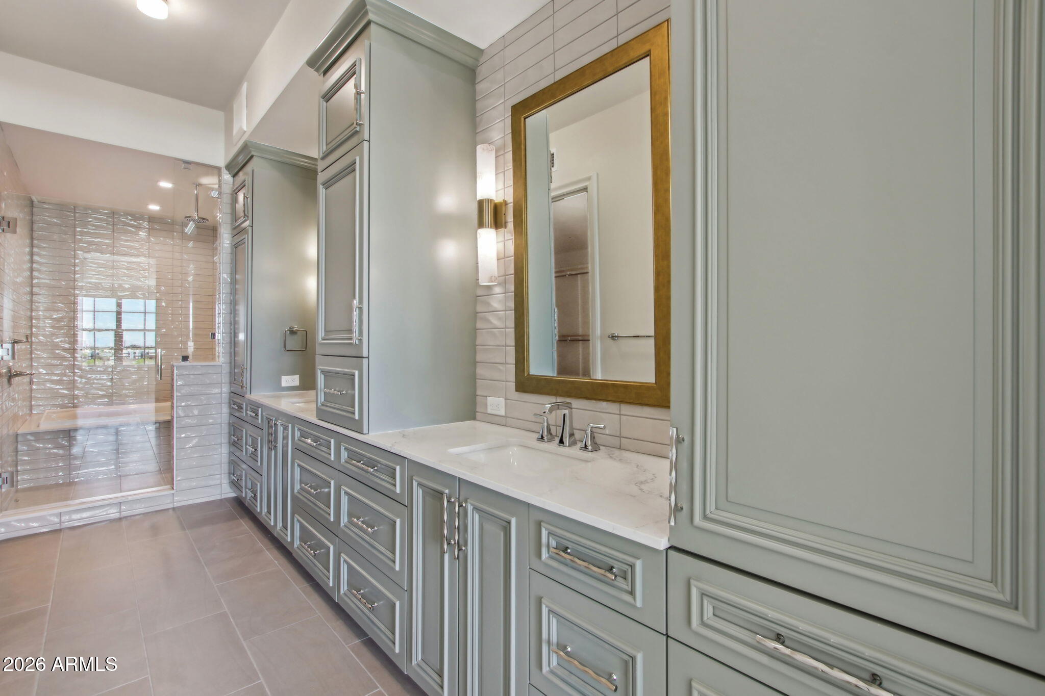 4240 East Camelback Road, Unit 514 Phoenix, AZ 85018 - Photo 8 of 16 a bathroom with a sink a mirror and a shower